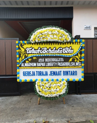 Papan Bunga Duka di Keagungan